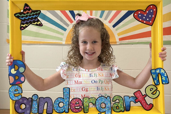 Picture of kindergarten girl, smiling proudly.