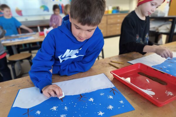 Student working on winter craft in art class.