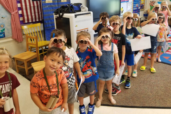 Picture of Kindergarteners looking through paper binoculars.