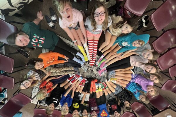 Aerial view of student's sitting in a circle.