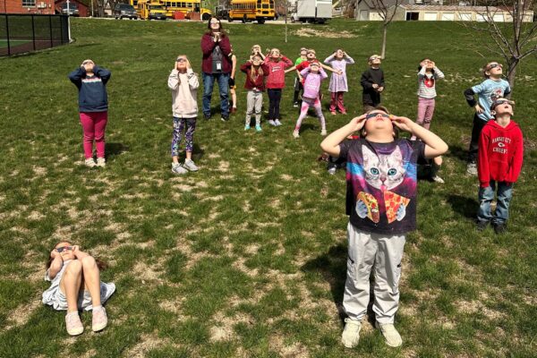 Kindergarten students looking at the solar eclipse.