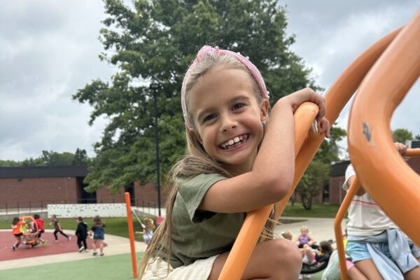 Student enjoying the weather outside at recess.