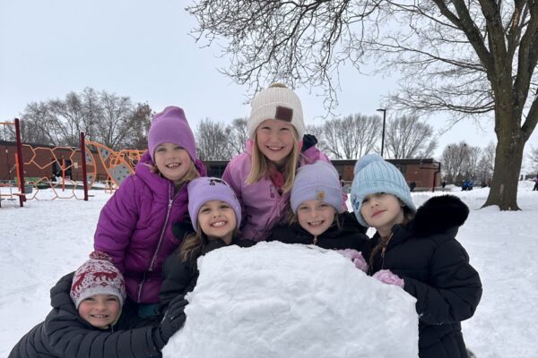 Students playing outside in the snow.